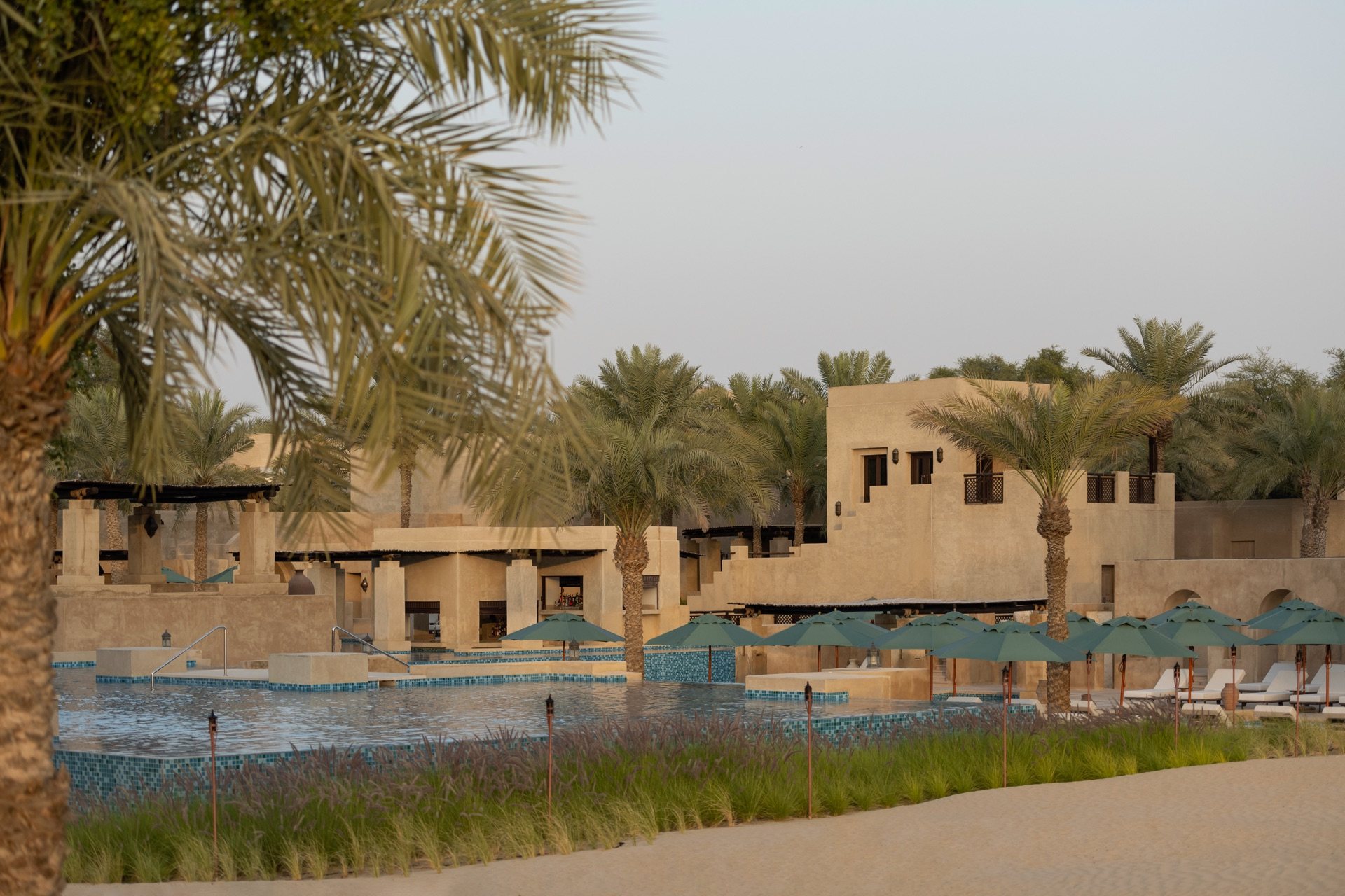 Desert resort pool and palms at golden hour