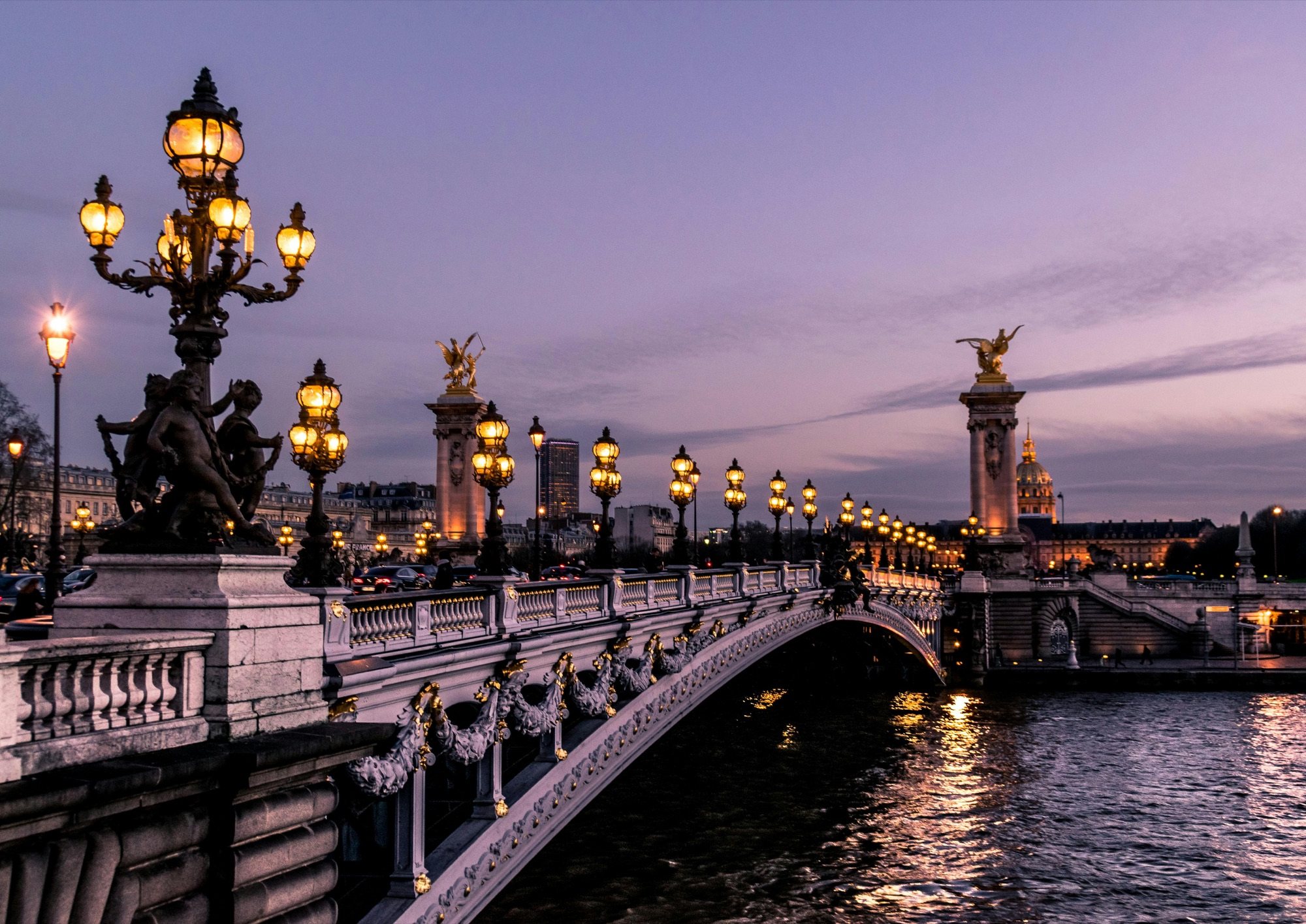 Pont Alexandre III and its golden lamps over the Seine at dusk, Paris